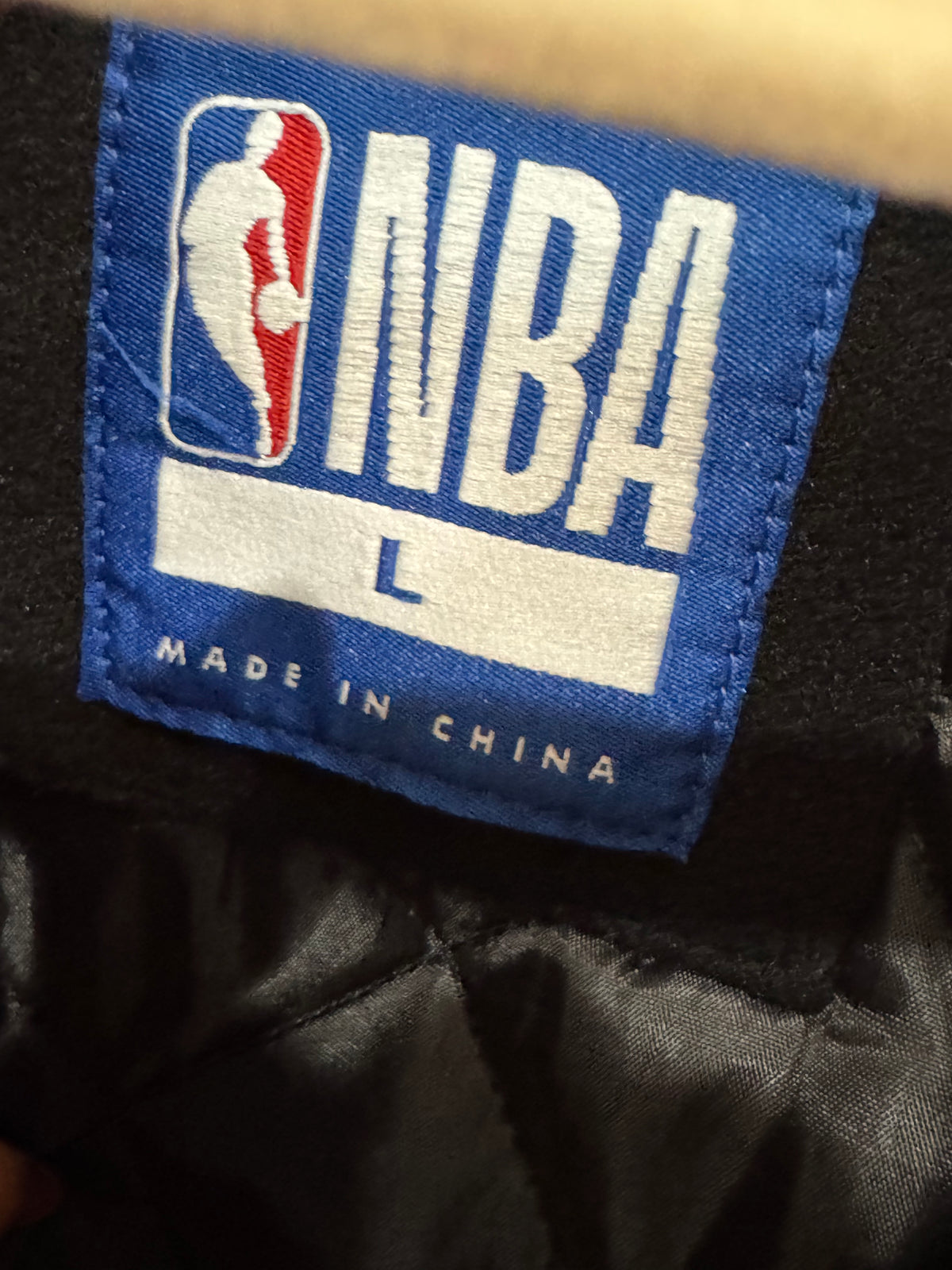 NBA official size large black and white varsity jacket wool-style body with contrasting sleeves and embroidered logos.