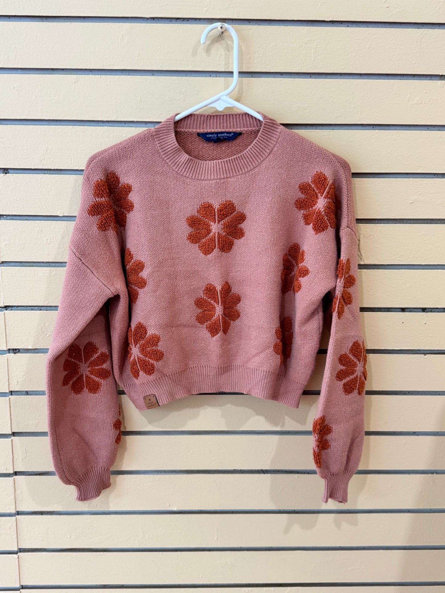 Simply Southern brand women’s Floral Rust Cropped Sweater size large featuring a dusty pink knit fabric and dark orange flower motifs.