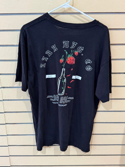 Black graphic tee from Lira Clothing size large rose-in-a-bottle design on the back.