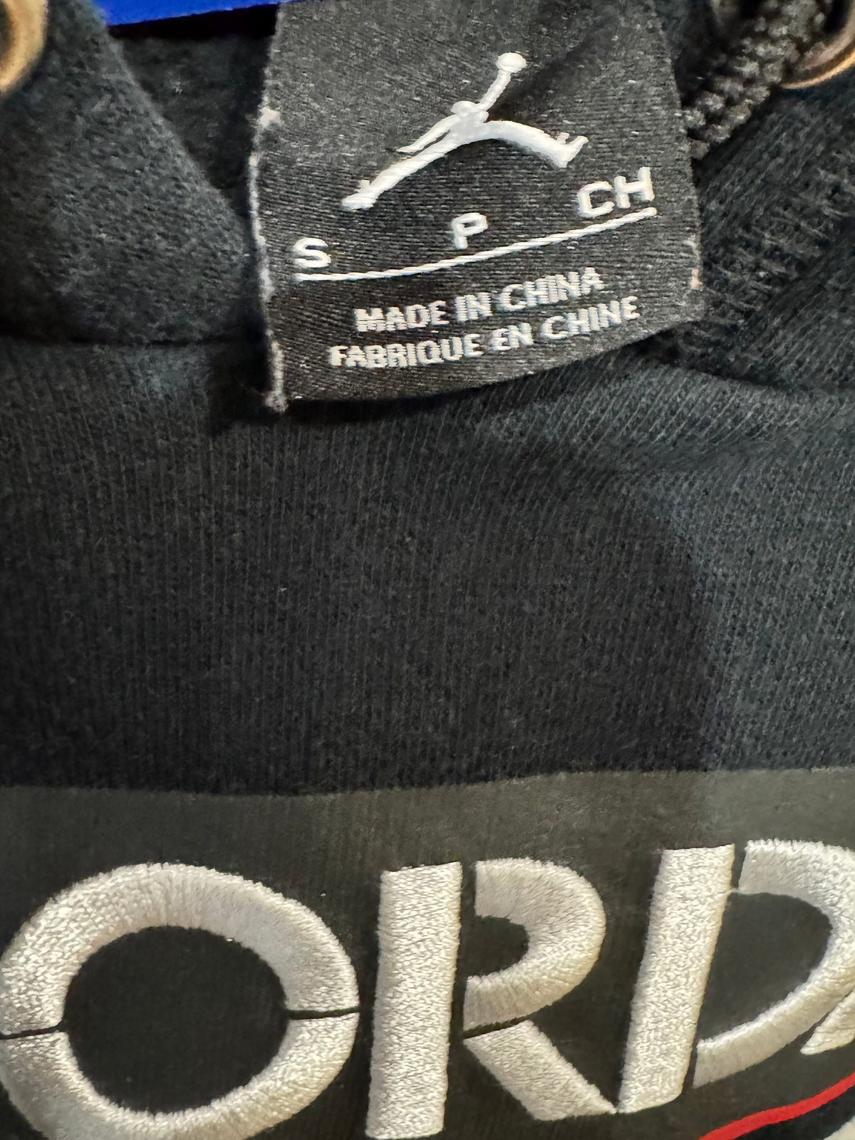 black Air Jordan crop hoodie size small features a distressed, raw-edge hem and prominently displays the iconic Jumpman logo over the number "23"