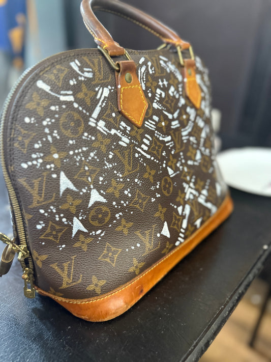 The Custom Authentic 1 of 1 Louis Vuitton Monogram Alma handbag is a luxurious and iconic piece