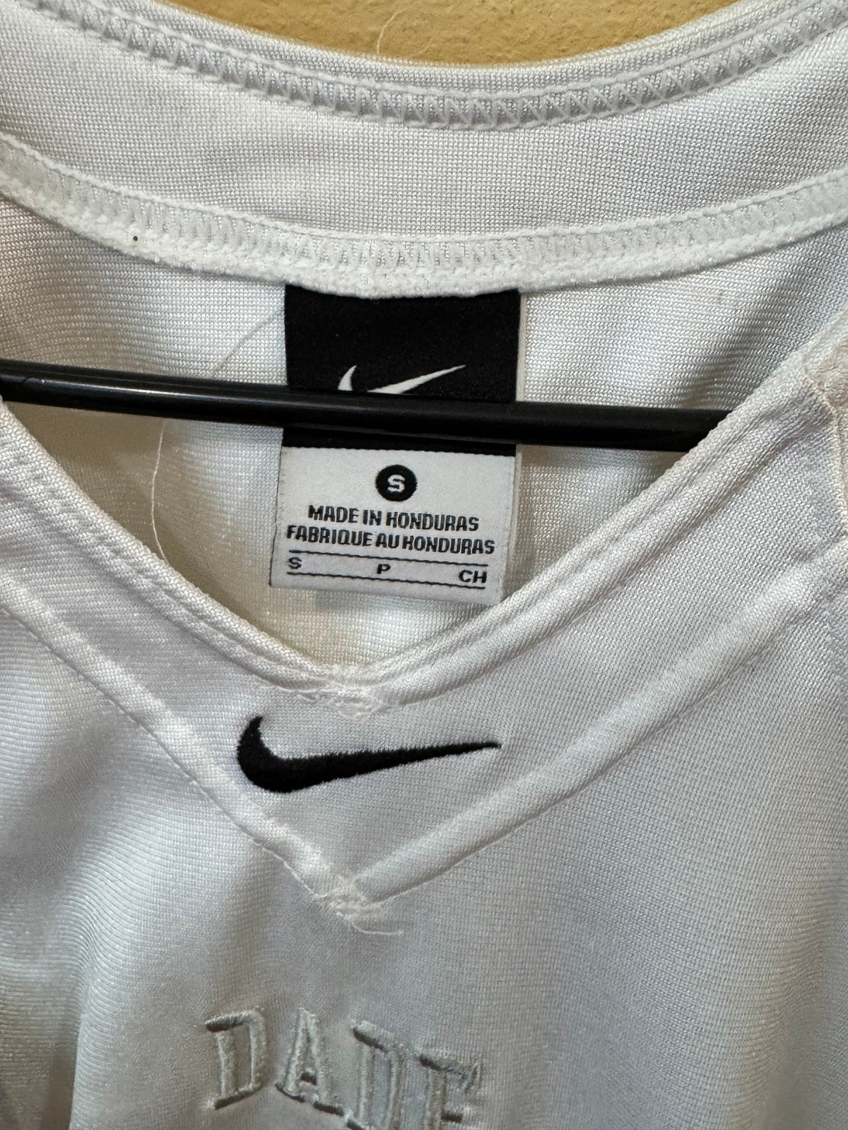 White Nike athletic football jersey size small featuring a large striped number "2" on the front and green sleeve cuffs.