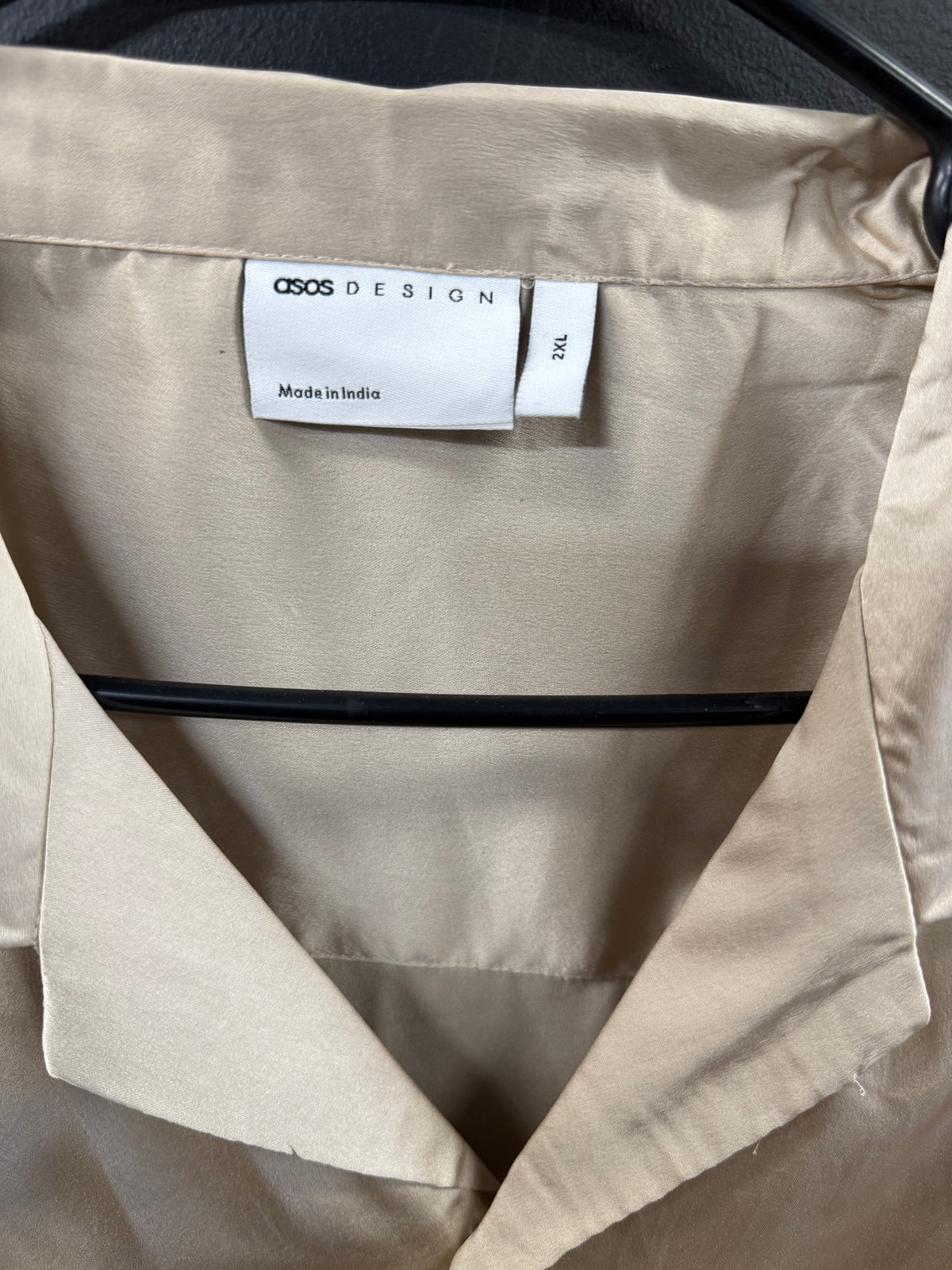 ASOS DESIGN short-sleeve satin camp-collar shirt in a smooth champagne hue.