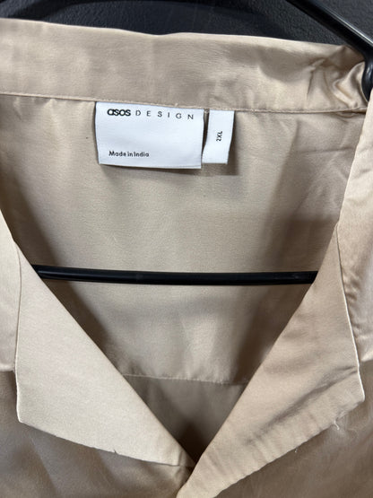 ASOS DESIGN short-sleeve satin camp-collar shirt in a smooth champagne hue.