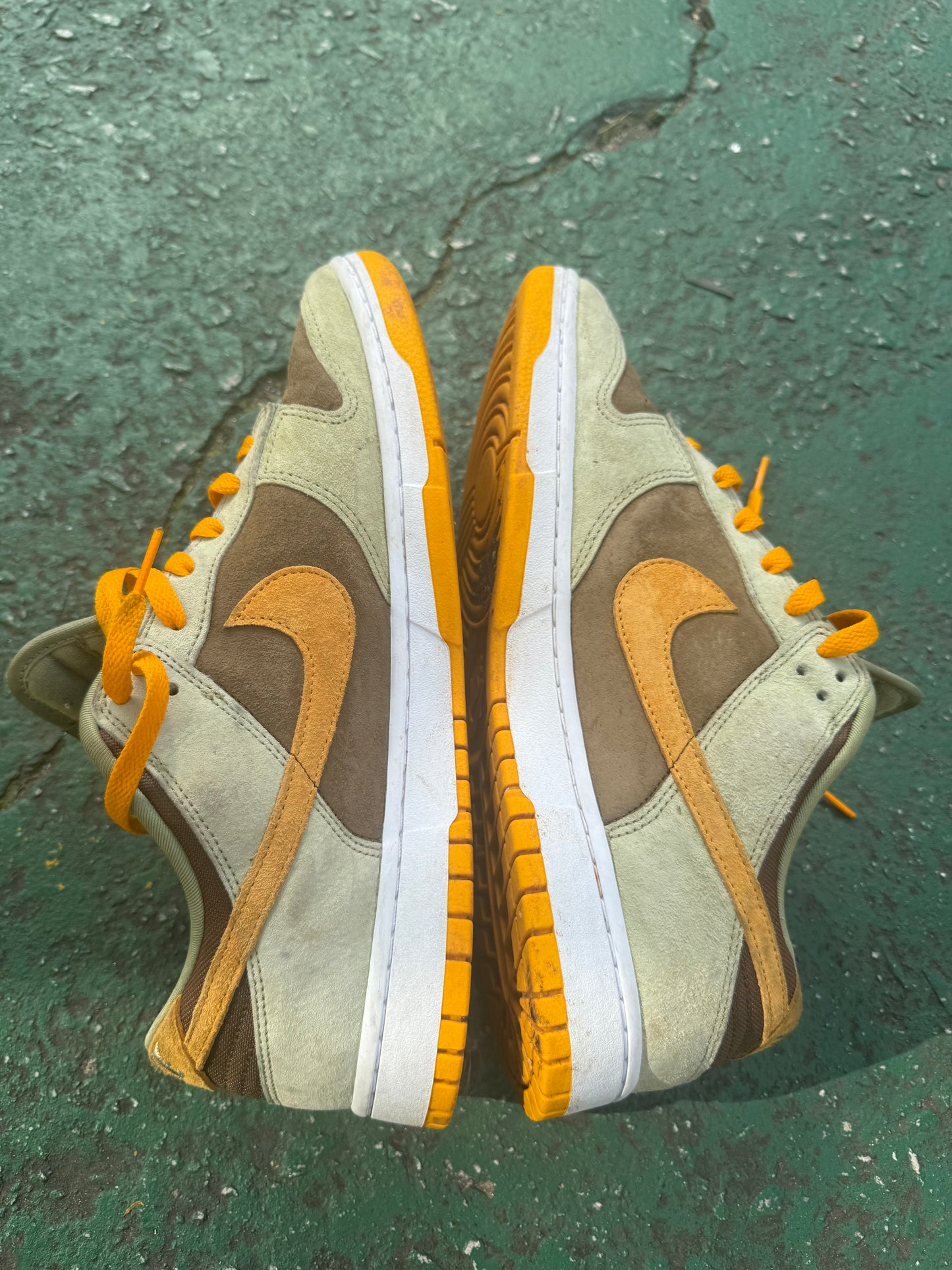 Nike Dunk Low 'Dusty Olive,' size 12 featuring a rustic brown suede base with olive overlays and bright orange laces.