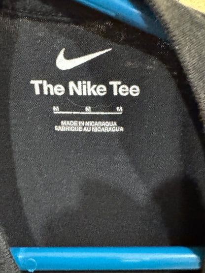 Nike Dry-FIT women's sleeveless tank top shirt featuring a large, white "JUST DO IT." graphic. Size medium