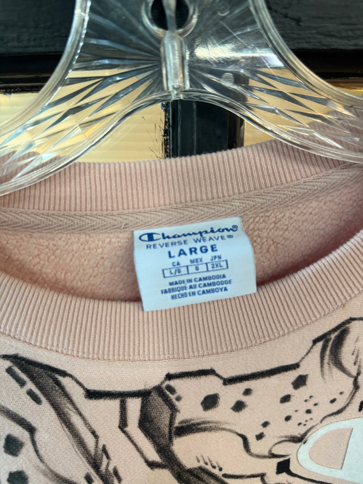 Champion Light Pink cropped crewneck sweatshirt, featuring an all-over black-and-white comic book panel manga sketch