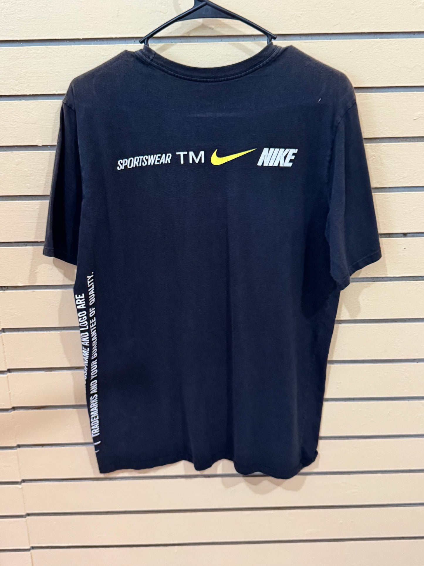 black Nike t-shirt features a large white swoosh logo size medium