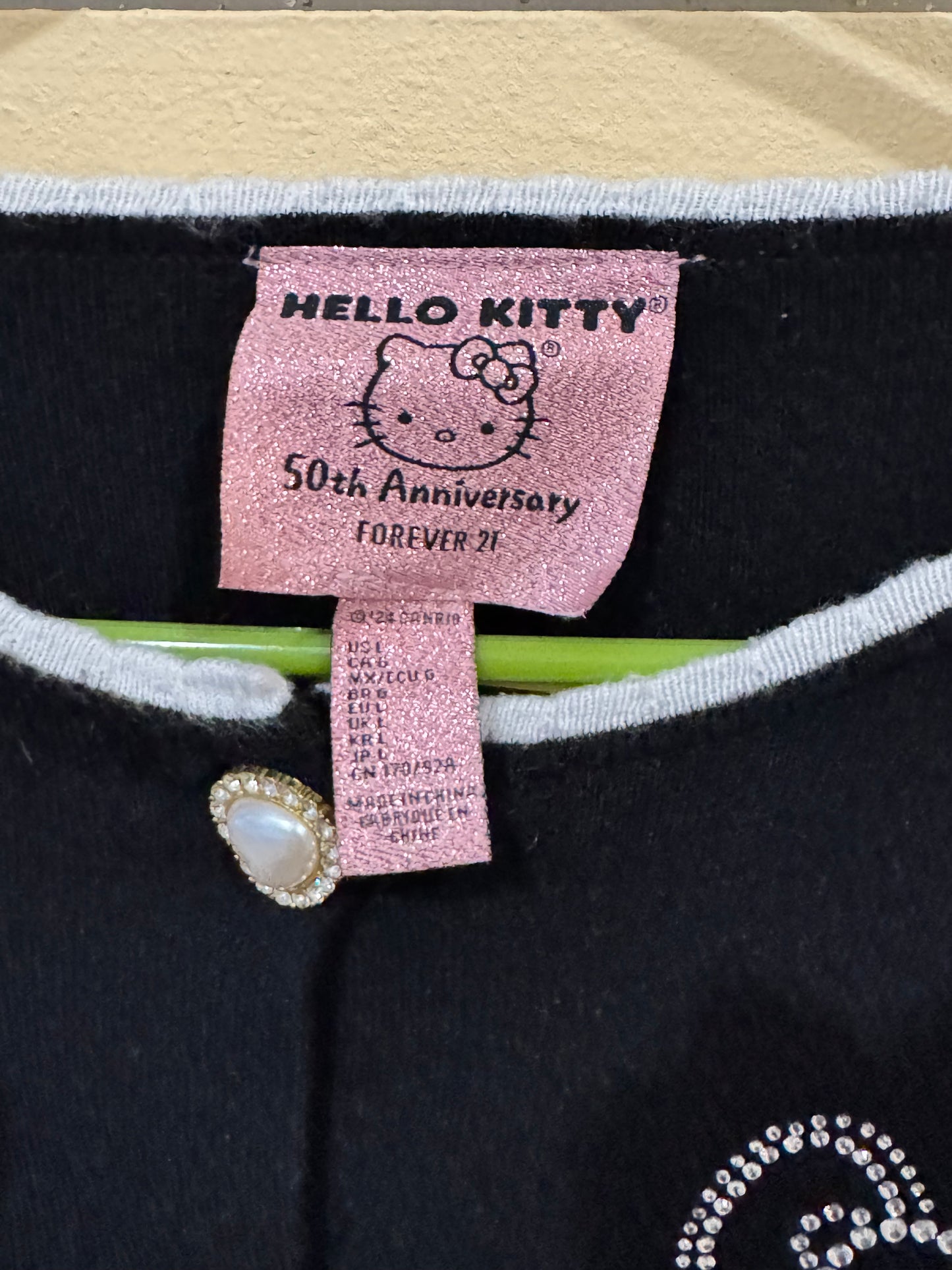 Hello kitty Forever 21 size large cardigan black cropped design rhinestone Hello Kitty bow accent and pearl-style buttons.