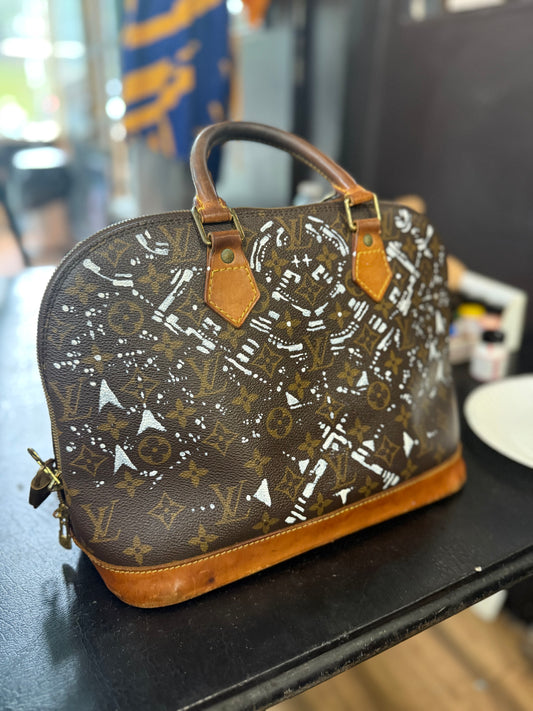 The Custom Authentic 1 of 1 Louis Vuitton Monogram Alma handbag is a luxurious and iconic piece