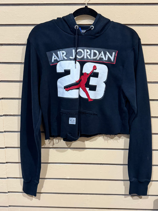 black Air Jordan crop hoodie size small features a distressed, raw-edge hem and prominently displays the iconic Jumpman logo over the number "23"
