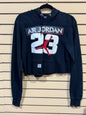 black Air Jordan crop hoodie size small features a distressed, raw-edge hem and prominently displays the iconic Jumpman logo over the number "23"