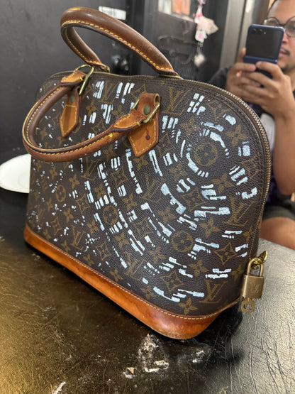 The Custom Authentic 1 of 1 Louis Vuitton Monogram Alma handbag is a luxurious and iconic piece