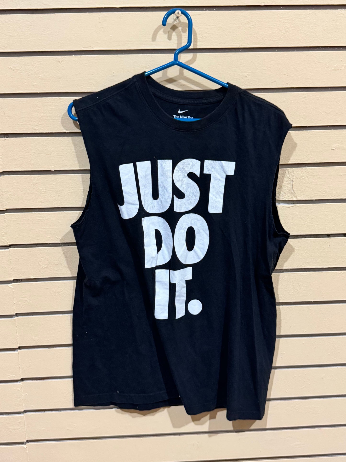 Nike Dry-FIT women's sleeveless tank top shirt featuring a large, white "JUST DO IT." graphic. Size medium